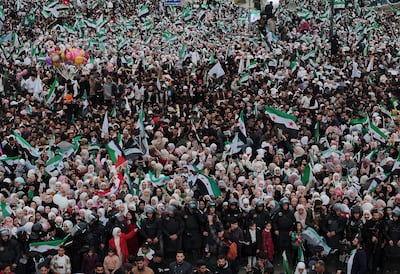 Crowds gather at Umayyad Square in Damascus to celebrate the anniversary of the downfall of Bashar Al Assad. AP