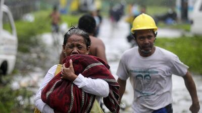 Power in many areas, including the business district of Makati, was cut just after dawn as branches were torn off trees and electricity lines snapped. Francis R Malasig/EPA