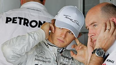 Nico Rosberg, the Mercedes GP driver, tries to talk to his engineer over noise on the track.