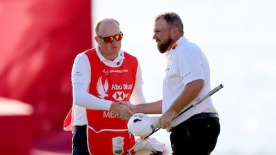 Shane Lowry shakes hands with caddie Adrian Meronk after finishing his round on day three of the Abu Dhabi HSBC Championship at Yas Links Golf Course on January 21, 2023. Getty
