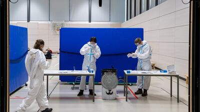 Workers administer rapid antigen tests to high school students at the Ehrenfried Walther von Tschirnhaus Gymnasium high school in Dresden, Germany. Getty Images