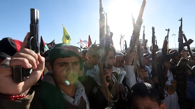 Houthi supporters hold their weapons up during an anti-US and anti-Israel protest in Sanaa, Yemen. EPA