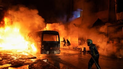 Members of the Syrian Civil Defence try to put out a fire after heavy shelling by the Syrian army on Kurdish-held areas in Aleppo. Reuters