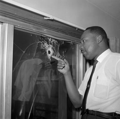 Dr Martin Luther King Jr. looks at a glass door of his rented beach cottage in St. Augustine, that was shot into. The house connected to King is now in the hands of a couple who plans to preserve it. AP
