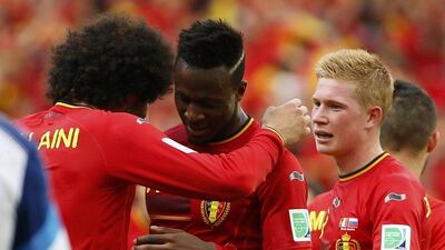 Divock Origi is embraced by Marouane Fellaini with Kevin De Bruyne nearby after his goal against Russia for Belgium on Sunday at the 2014 World Cup in Rio de Janeiro, Brazil. Yves Herman / Reuters / June 22, 2014