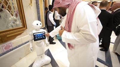 An attendee at the 2019 Future Investment Initiative in Riyadh last October finds out event information on a tablet carried by a robot. This year's event is set to attract more than 6,000 atendees from 110 countries. Bloomberg