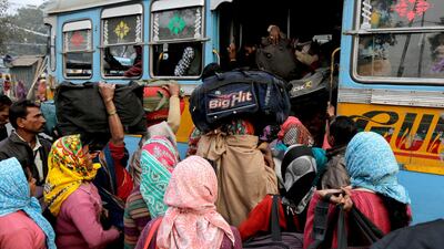 Hindu pilgrims board a bus on the way to Gangasagar, in Kolkata, India, on January 13, 2018. Bikas Das / AP