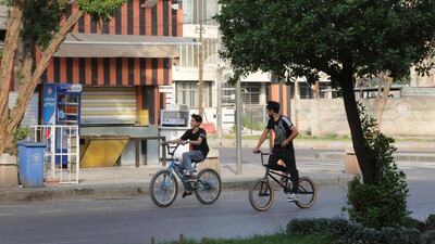 Iraqi youths ride their bicycles in the Karrada district of Iraq's capital Baghda, during a total curfew imposed by authorities to curb Covid-19 coronavirus cases. AFP