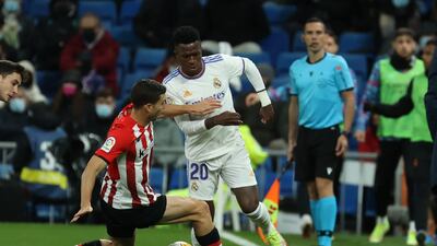 Real Madrid striker Vinicius Jr takes on Athletic defender Oscar de Marcos. EPA