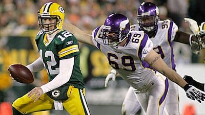 Even with Jared Allen, the Vikings defensive end, lurking, right, Aaron Rodgers produced another four touchdown game in Green Bay's 45-7 win.