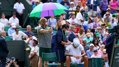 Nick Kyrgios receives treatment from the on-court physio. PA