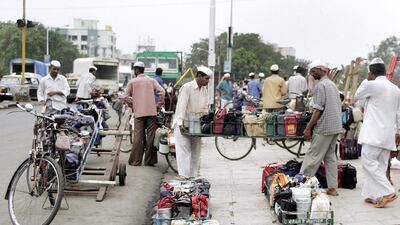 Indian dabbawalas load tiffin boxes onto their bicycles before delivering them to offices in Mumbai. Sebastian D'Souza / AFP