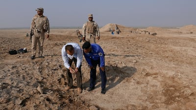 Looting holes in Tello, Iraq. Courtesy British Museum