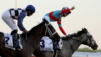 Japan's Yutaka Take (R) gestures after leading Lani to win the UAE derby during the Dubai World Cup horse racing event on March 26, 2016 at the Meydan racecourse in the United Arab Emirate of Dubai. AFP / MARWAN NAAMANI