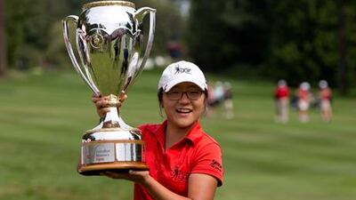 15-year-old Lydia Ko celebrates with the Canadian Women's Open trophy after winning in Vancouver.