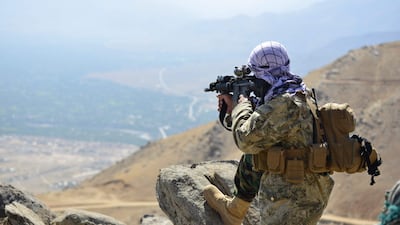 An anti-Taliban fighter takes a postion on a hilltop. Several thousand fighters are reported to be holding out against the Taliban in the region. AFP