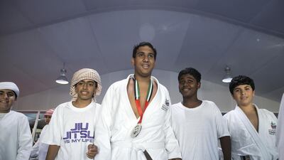 Emirati Khaled Omar Seraihi, centre, from Ag 06-Al Abbas Bin Abdel Muttalib school in Ruwais, walks with his friends after he had won a silver medal in the male white teen +70,5Kg division during the 2015 Abu Dhabi World Children’s Cup, April 21, 2015, at the IPIC Arena in Abu Dhabi. Silvia Razgova / The National