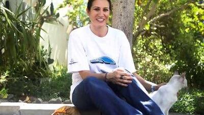 Linda Salem strokes Latte, one of the many cats she cares for.