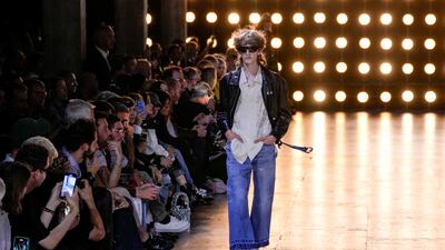 At the show, Celine designer Hedi Slimane sent out a line-up of bare-chested models in sheer, unzipped tops and dazzling blazers, marking the return of French label to Paris Fashion Week's menswear shows. AP