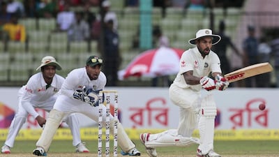 Wicketkeeper Litton Das, centre, and Shakib Al Hasan, left, watch helplessly as India’s Shikhar Dhawan attacks Bangladesh’s spinners in Fatullah on Wednesday. AM Ahad / AP Photo