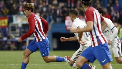 Atletico Madrid’s French striker Antoine Griezmann, left, escapes with the ball. Emilio Naranjo / EPA