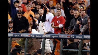 What a catch: San Francisco Giants first baseman Brandon Belt falls into the stand with the fans as he makes a diving catch Game 1 of the National League division series in San Francisco. Marcio Jose Sanchez / AP Photo