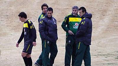Dunga, right, the Brazil coach, and the team's technical staff watch as Elano, left, limps off a training session on Tuesday.