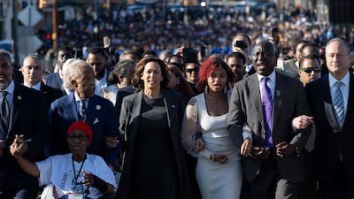 US Vice President Kamala Harris, second from left, her husband Doug Emhoff, right, civil rights laywer Ben Crump, second right, and Rev Al Sharpton, second left, join a march across the Edmund Pettus Bridge during a commemoration of the 59th anniversary of Bloody Sunday in Selma, Alabama. AFP