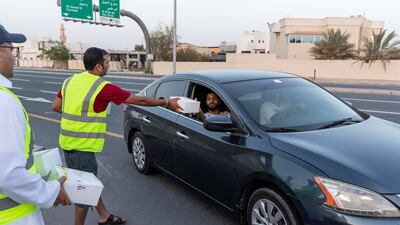 Iftar meals being distributed to motorists. Antonie Robertson / The National