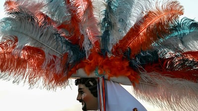 A man wears a traditional feathered 'huehue' costume in Tlaxcala state, Mexico. AFP