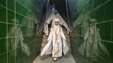 Young Iraqi girls take part in a ceremony at Basra International Stadium, having reached hijab age. AFP