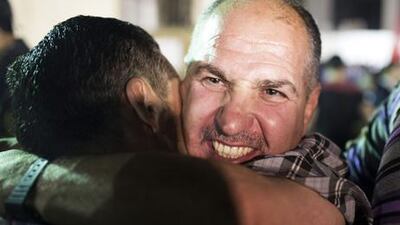 RAMALLAH, WEST BANK - AUGUST 14: A Palestinian prisoner released from an Israeli jail hugs his supporters in the Mikatah compound on August 14, 2013 in Ramallah, West Bank. Israel announced that 26 Palestinian prisoners will be released, 15 to Gaza and 11 sent to West Bank, as part of Israeli-Palestinian negotiations. (Photo by Ilia Yefimovich/Getty Images)