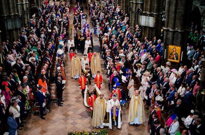 The king and queen leave Westminster Abbey following the coronation ceremony in London. AP