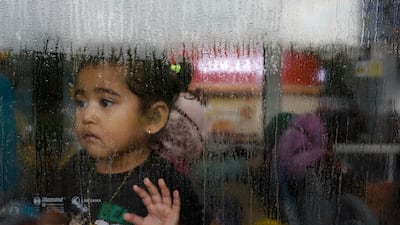 A girl evacuated from Sudan looks through the window of a bus after arriving in Jakarta, Indonesia. Reuters
