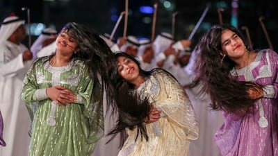 Al-Ayyala dancers move in unison to a drummed rhythm at Al Hosn Festival. Khushnum Bhandari / The National