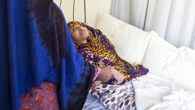 Fatima Hussein comforts her daughter Maymonah Mohammed at Sharjah’s Al Qasimi Hospital. The 22-year-old is lying in the hospital bed for the past 14 months after being hit by a car while crossing a busy street in the Al Taawun neighbourhood. Reem Mohammed / The National