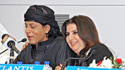 Bollywood director Farah Khan gives actor Shah Rukh Khan, left, a hug during a news conference at the Atlantis Hotel on The Palm Jumeriah this week. Jeff Topping for The National
