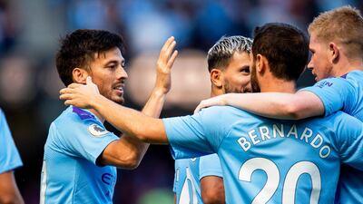 Manchester City's David Silva celebrates with teammates. AFP