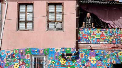 Muhammed Yalcin, a 30-year-old painter, poses on the balcony of his house in the Altindag district of Ankara, Turkey. All photos: AFP
