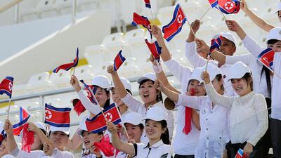 North Korea fans cheer on their team against Qatar. EPA