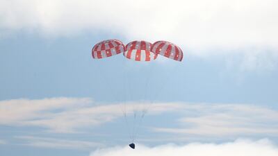 The Orion capsule prepares for splash down in the Pacific Ocean after travelling more than 2.2 million km on a path around the Moon. Getty