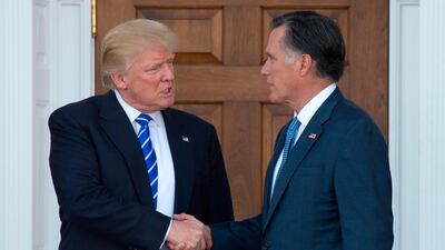 President Donald Trump shakes hands with Mitt Romney after their meeting at the clubhouse of Trump National Golf Club in Bedminster. AFP