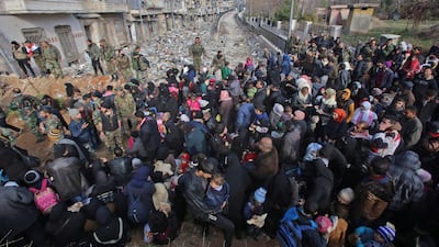 East Aleppo residents fleeing the violence gather at a checkpoint manned by pro-government forces in the city's Maysaloun neighbourhood on December 8, 2016. Youssef Karwashan/AFP
