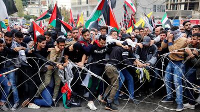 Protesters try to remove barbed wire on a road leading to the US embassy in Awkar, Lebanon during a demonstration on December 10, 2017. Bilal Hussein / AP Photo