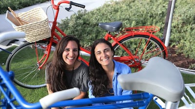 Sisters Rania, right, and Zaina Kanaan at their second-hand bike business stall at the Ripe Market at the new Mushrif Central Park in Abu Dhabi. Ravindranath K / The National
