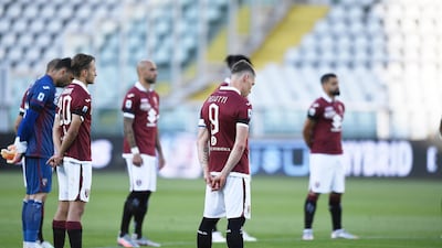 Players observe a minute of silence to honour the victims of coronavirus, prior to the Serie A match between Torino and Parma. AP Photo