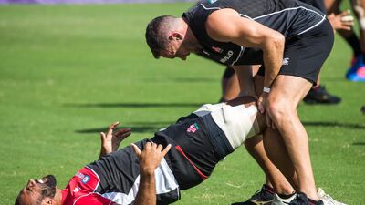 Japan's flanker Michael Leitch receives attention on the pitch during a training session. AFP