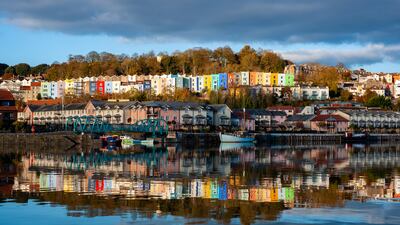 Colourful houses reflected in the River Frome in Bristol. Getty Images