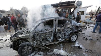 Smoke rises from a burnt car at the site of a truck blast in Azaz, Syria. REUTERS