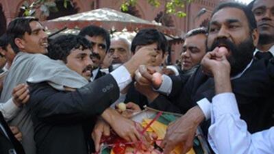 Pakistani lawyers share traditional sweets to celebrate the government decision to reinstate the chief justice Iftikhar Mohammed Chaudhry in Lahore, Pakistan.
